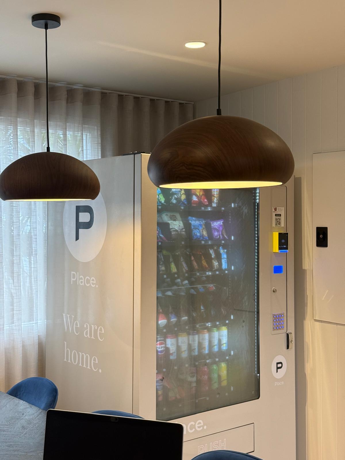 Custom branded Place. vending machine close-up with pendant lights